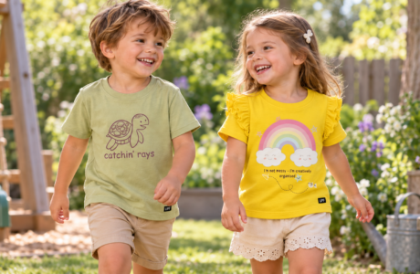 Toddler boy and girl wearing matching catchin’ rays UPF T-shirts outdoors