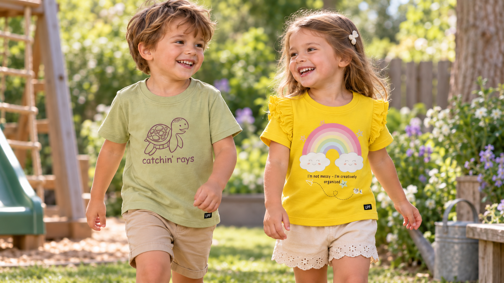 Toddler boy and girl wearing matching catchin’ rays UPF T-shirts outdoors